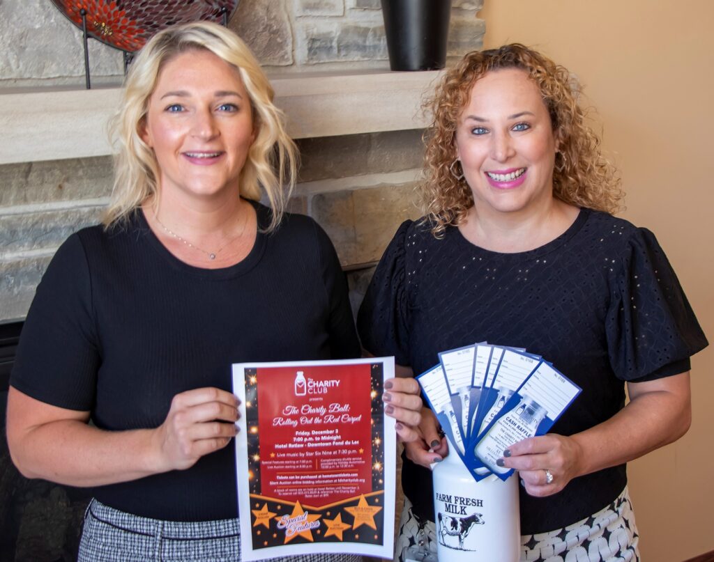 Two females holding a poster